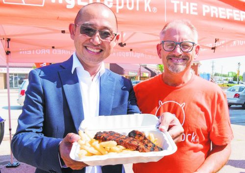 SVJETLANA MLINAREVIC THE CARILLON ARCHIVES 

HyLife will be feeding at least 2,000 with its Grillin’ for Good campaign to raise money for four local food banks in Neepawa, Killarney, La Broquerie, and Steinbach this summer. Here HyLife CEO Karan Sangfai (left) and Earl’s Meat Market owner and Steinbach Mayor Earl Funk attend one of HyLife’s customer appreciation lunches in 2024 where the HyLife food truck fed 600 people.