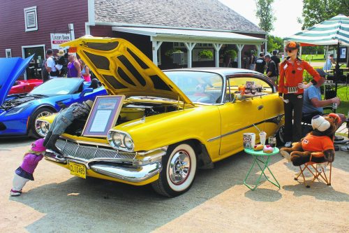 GRAHAM WALKER, The Carillon 

Fred Hasey’s 1960 Dodge Dart Pioneer is displayed with a complete ensemble crew from the classic A&W drive-in era that convinces the admirer they have really stepped back in time to wonder where the waitress on roller skates is with their milkshake.