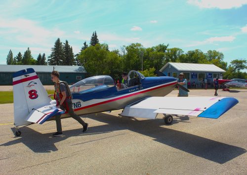 GRAHAM WALKER THE CARILLON 

Adam Peters (17) pushes his Vans RV-8 back from refueling with the help of his ground crew, father Brian Peters and technical director Matt Granson, after completing his morning flight in the three-run competition of the championships held at his home airfield of Steinbach.