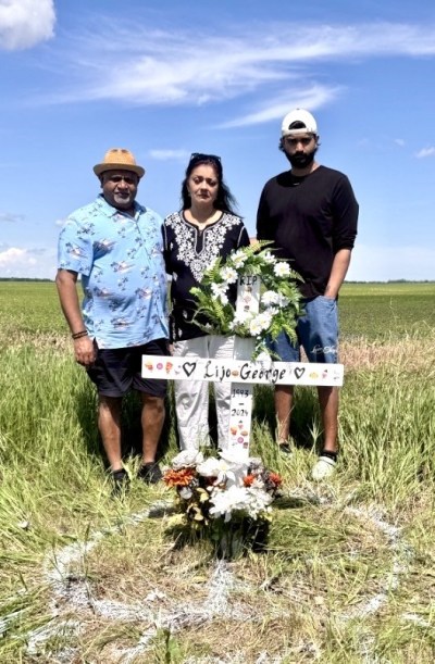 SUPPLIED 

On June 26, at the crash site with the cross marking the intersection of Highways 200 and 23, from left: Saji John, Dr MaryAnne John, and Akash John.