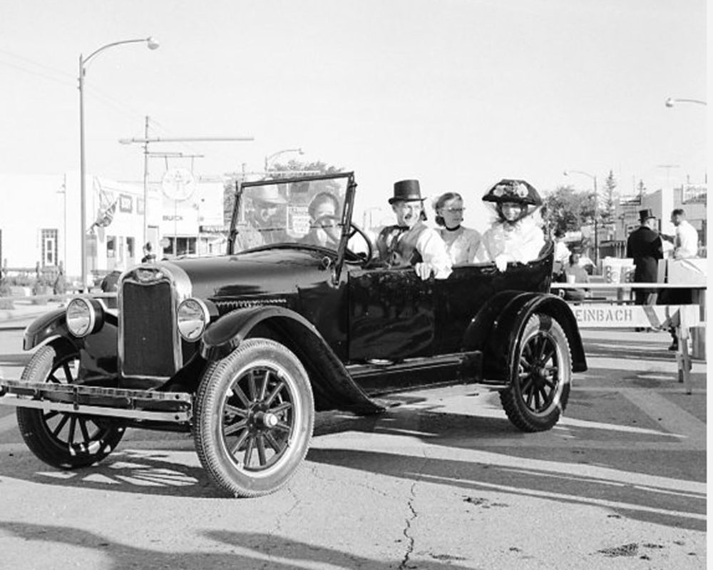 CARILLON ARCHIVES
Riding in style in a vintage automobile and arriving early for the 90th Anniversary breakfast on Main Street are Ken Betzold, Grace Reimer, Lorenna Reimer and Faith Rempel. At right, a committee member discusses the menu with a volunteer while empty tables await the onslaught of hungry visitors.