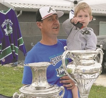 Watch the parade dad! Jared Driedger tries to explain to his son, Wade, how the Southeast Prairie Thunder finally won the Allan Cup in the spring. The young tyke was more interested in the Hanover Ag Fair parade than hearing about the Allan Cup. Driedger, a defenceman with the Thunder, and manager Marv Kornelsen, had the Allan Cup on display during the parade, one of the final stops, before the Cup was to be returned to the Hockey Hall of Fame in Toronto.