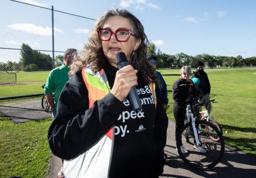 SVJETLANA MLINAREVIC THE CARILLON
Winnipeg's Bike Mayor Patty Wiens speaks to a large crowd in La Broquerie prior to a community bike ride on Sept. 13, 2026, starting at Tetrault Park. The La Broquerie trail system has 22 kilometres of trails that take walkers and cyclists through and out of the LUD. Wiens cycled five hours from Winnipeg to La Broquerie to participate in the ride.
