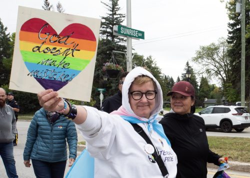 SVJETLANA MLINAREVIC THE CARILLON
OPEN for Peace founder Dr. T. Sheppard-Luangkhot holds on a sign while walking down Main Street during Steinbach Pride on Sept. 12, 2026. Sheppard-Luangkhot created Awesome Queer Kids group for trans and queer gender expansive kids in Steinbach.