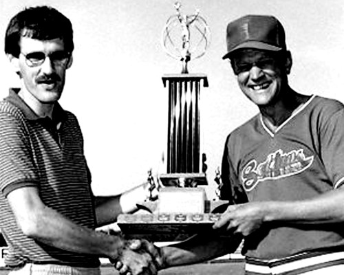Hanover Fastball Association president John Neufeld presents the Steinbach A&W Trophy to Friedensfeld coach Wally Rempel after the Sultans defeated the Pacers three games to one in the finals.