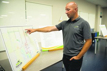 SVJETLANA MLINAREVIC THE CARILLON
Town of NIverville manager of engineering Daniel Wiebe points to at-risk infrastructure in the town's core and to the west as being affected by climate change during the town's Climate Action Plan open house on Aug. 20, 2026.