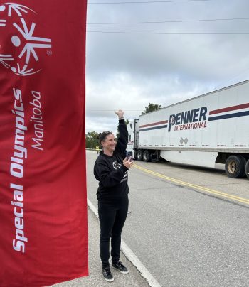 GREG VANDERMEULEN THE CARILLON 

Mallory Cordingley, Special Olympics Manitoba senior manger of sponsorships and events, waves as the trucks pass during the convoy on Sept. 12 that began at Ile des Chenes.