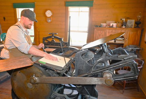MENNONITE HERITAGE VILLAGE 

Jared Penner, one of our enthusiastic printery volunteers, demonstrates various aspects of the printing press.