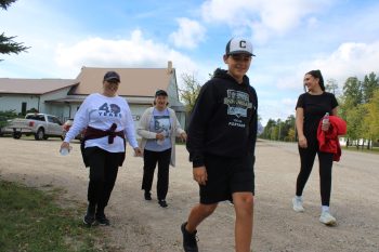GREG VANDERMEULEN THE CARILLON 

Organizer Judy Preteau walks with members of her family.
