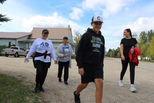 GREG VANDERMEULEN THE CARILLON 

Organizer Judy Preteau walks with members of her family.