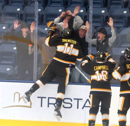 Ty Brewster celebrates his overtime game winner with members of the Steinbach Pistons Oct. 14. (Cassidy Dankochik The Carillon)