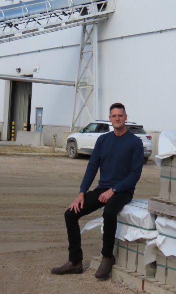 WES KEATING THE CARILLON 

As much as things may change, some things stay the same. A pallet of Barkman stone in the Steinbach yard still provides a Carillon photographer with a convenient place for a photo of the latest CEO with the plant in the background.